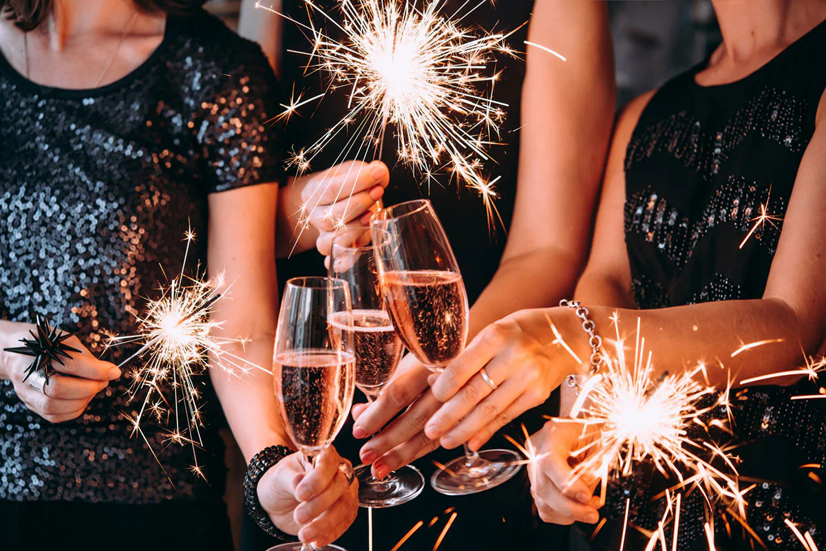 New Year's Eve Champagne Survival Guide: Tips and Tricks for a Fizzy and Festive Celebration 1 New Years eve celebration with champagne and sparklers. TAG Liquor Stores Canada | Beer, Wine, Spirits & Gift Baskets Canada-wide Delivery